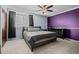 Spacious bedroom with neutral carpet, ceiling fan and a purple accent wall at 17613 E Ohio Cir, Aurora, CO 80017
