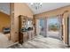 Bright dining area with an antique hutch, sliding glass doors to a deck, and wood-look flooring at 17613 E Ohio Cir, Aurora, CO 80017