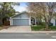 Charming single-Gathering home showcasing a well-kept lawn, driveway, and attached two-car garage at 17613 E Ohio Cir, Aurora, CO 80017