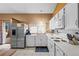 Bright kitchen with white cabinets, stainless steel refrigerator, and modern appliances at 17613 E Ohio Cir, Aurora, CO 80017