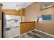 Kitchen featuring white appliances, white cabinets and a view to the dining area at 17613 E Ohio Cir, Aurora, CO 80017