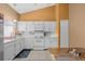 Charming kitchen with white cabinets, tile backsplash, and modern appliances at 17613 E Ohio Cir, Aurora, CO 80017