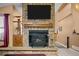 Close-up of stone fireplace with wooden mantel, creating a cozy focal point at 17613 E Ohio Cir, Aurora, CO 80017