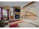 Comfortable living room features a stone fireplace and ample seating with neutral tones at 17613 E Ohio Cir, Aurora, CO 80017