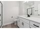 Modern bathroom with white vanity, shower, and gray floor tiles at 4704 Twelve Oaks Way, Castle Rock, CO 80104