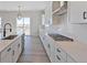 Modern kitchen with white cabinets, quartz countertops, and a gas cooktop at 4704 Twelve Oaks Way, Castle Rock, CO 80104