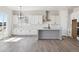 Modern kitchen with white cabinets, an island, and stainless steel appliances at 4704 Twelve Oaks Way, Castle Rock, CO 80104