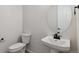 Small powder room with pedestal sink and toilet at 4704 Twelve Oaks Way, Castle Rock, CO 80104