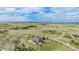 Wide aerial perspective shows a house surrounded by green fields, with roads winding through a landscape under a cloudy sky at 555 Heritage Trl, Elizabeth, CO 80107