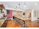 Entertainment bar area with a large granite countertop, seating for six, open shelving, and custom decor elements at 555 Heritage Trl, Elizabeth, CO 80107
