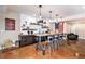 Entertainment bar area with a large granite countertop, seating for six, open shelving, and custom decor elements at 555 Heritage Trl, Elizabeth, CO 80107