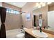 Cozy bathroom with a bathtub shower combination, tile walls, and a neutral color scheme, enhancing its welcoming atmosphere at 555 Heritage Trl, Elizabeth, CO 80107