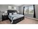 Spacious bedroom with a large window view and dark wood furniture at 555 Heritage Trl, Elizabeth, CO 80107