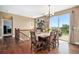 Dining area with wood table, seating for six, hardwood floors, and sliding glass doors to outside at 555 Heritage Trl, Elizabeth, CO 80107