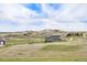 A sprawling home featuring views of the open landscape with rolling hills in the distance under a partly cloudy sky at 555 Heritage Trl, Elizabeth, CO 80107