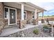 Inviting front porch with charming decor elements and stone supports at 555 Heritage Trl, Elizabeth, CO 80107