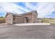 Spacious detached garage, offering ample parking and storage space with well paved driveway at 555 Heritage Trl, Elizabeth, CO 80107