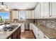 Well-lit kitchen featuring granite countertops, stylish backsplash, and stainless steel appliances at 555 Heritage Trl, Elizabeth, CO 80107