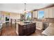 Bright, open kitchen with stainless steel appliances, granite countertops, and a dark wood island at 555 Heritage Trl, Elizabeth, CO 80107
