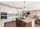 Charming kitchen boasting an island with white cabinets and granite countertop and stainless steel appliances at 555 Heritage Trl, Elizabeth, CO 80107