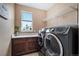 Efficient laundry room featuring modern front-load washer and dryer, built-in storage, and bright natural light at 555 Heritage Trl, Elizabeth, CO 80107