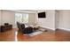 Comfortable living room with a plush leather recliner, mounted television, and a stylish area rug at 555 Heritage Trl, Elizabeth, CO 80107