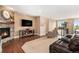Inviting living room features hardwood flooring, fireplace and staircase at 555 Heritage Trl, Elizabeth, CO 80107
