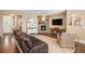 Cozy living room featuring a stone fireplace, hardwood floors, and comfortable seating at 555 Heritage Trl, Elizabeth, CO 80107