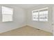 Bedroom featuring neutral carpet and two windows with blinds at 13487 Valentia St, Thornton, CO 80602