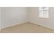 A bright bedroom featuring neutral carpet, white walls and a window providing natural light at 13487 Valentia St, Thornton, CO 80602