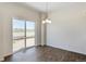 Dining area featuring a sliding glass door and contemporary chandelier at 13487 Valentia St, Thornton, CO 80602
