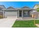 Charming single-story home with a well-manicured lawn and an attached two-car garage at 13487 Valentia St, Thornton, CO 80602