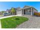 Single-story home with a tidy front lawn, rock landscaping, and an attached two-car garage at 13487 Valentia St, Thornton, CO 80602
