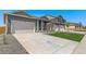 Lovely gray home featuring an attached garage and landscaped front yard at 13487 Valentia St, Thornton, CO 80602