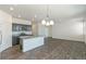 Bright kitchen with a center island and dark wood cabinets in an open-concept layout at 13487 Valentia St, Thornton, CO 80602