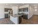 Kitchen featuring granite countertops, stainless steel appliances, and dark wood cabinetry at 13487 Valentia St, Thornton, CO 80602