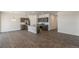 Open-concept kitchen and living area with wood-look floors and stainless steel appliances at 13487 Valentia St, Thornton, CO 80602