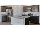 Modern kitchen features stainless steel appliances, granite countertops, and a spacious island at 13487 Valentia St, Thornton, CO 80602