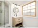 Well-lit bathroom showcasing a glass door shower and a wooden vanity with drawers at 6889 Frying Pan Rd, Boulder, CO 80301