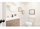 Clean, modern bathroom with a sink vanity, round mirror, and tiled flooring at 6889 Frying Pan Rd, Boulder, CO 80301