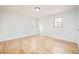 Bright bedroom features hardwood floors, neutral walls, and natural light from two windows at 6889 Frying Pan Rd, Boulder, CO 80301