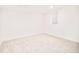 Simple bedroom with neutral carpet, white walls, and a window for natural light at 6889 Frying Pan Rd, Boulder, CO 80301