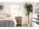 This staged bedroom features a light wood nightstand and a tall, vibrant green tree at 6889 Frying Pan Rd, Boulder, CO 80301