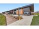 Modern building with a wood walkway, concrete patio, and meticulously maintained landscaping at 6889 Frying Pan Rd, Boulder, CO 80301