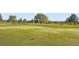 Lush green golf course with manicured fairways, flagpoles, and mature trees under a sunny sky at 6889 Frying Pan Rd, Boulder, CO 80301