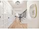 Bright hallway featuring hardwood floors, black metal railing, and modern light fixtures at 6889 Frying Pan Rd, Boulder, CO 80301