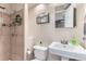 Small bathroom featuring shower with tile surround, toilet, and pedestal sink with mirror at 10360 Irving Ct, Westminster, CO 80031