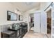 Stylish bathroom with dual vessel sinks, modern fixtures, and access to a walk-in closet at 10360 Irving Ct, Westminster, CO 80031