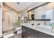 Modern bathroom features double sink vanity, tiled shower with glass door, and neutral color palette at 10360 Irving Ct, Westminster, CO 80031
