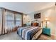 Cozy bedroom with natural light, a colorful bedspread, and bright turquoise nightstands at 10360 Irving Ct, Westminster, CO 80031